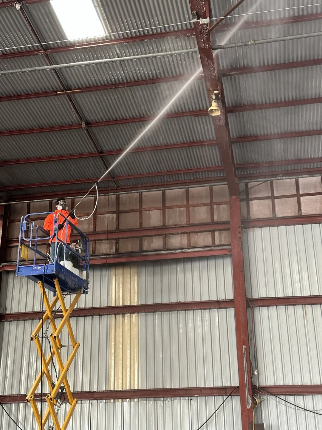 Scrub Hub team washing the inside of a warehouse roof